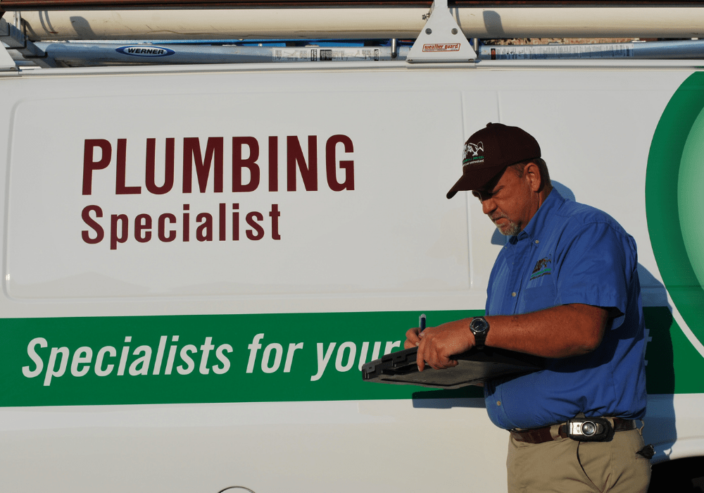 a plumber writing up a report on a plumbing repair for a business